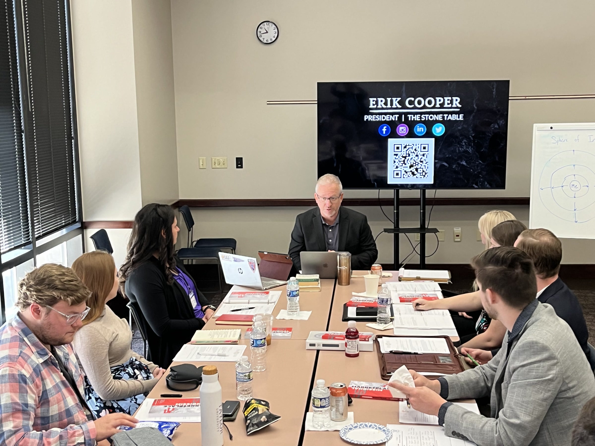 Erik Cooper, President of The Stone Table, speaking to a table of leaders.