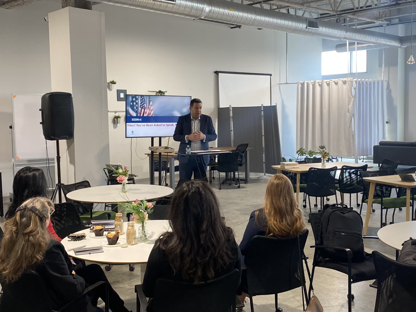 A speaker leading a public speaking workshop session.